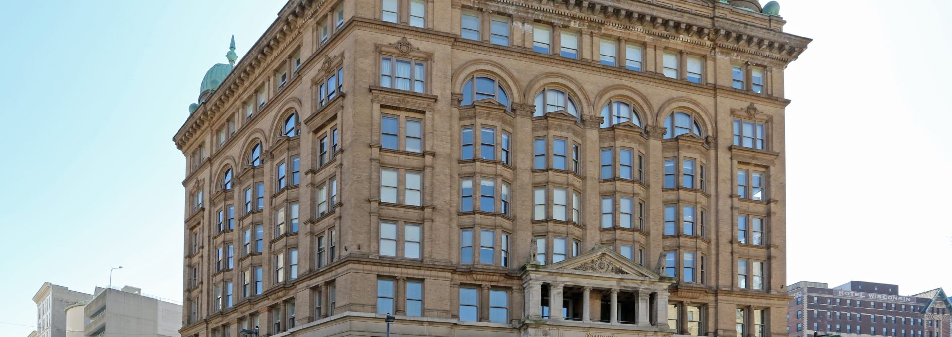 a large building with a clock tower on top at The Germania Apartments